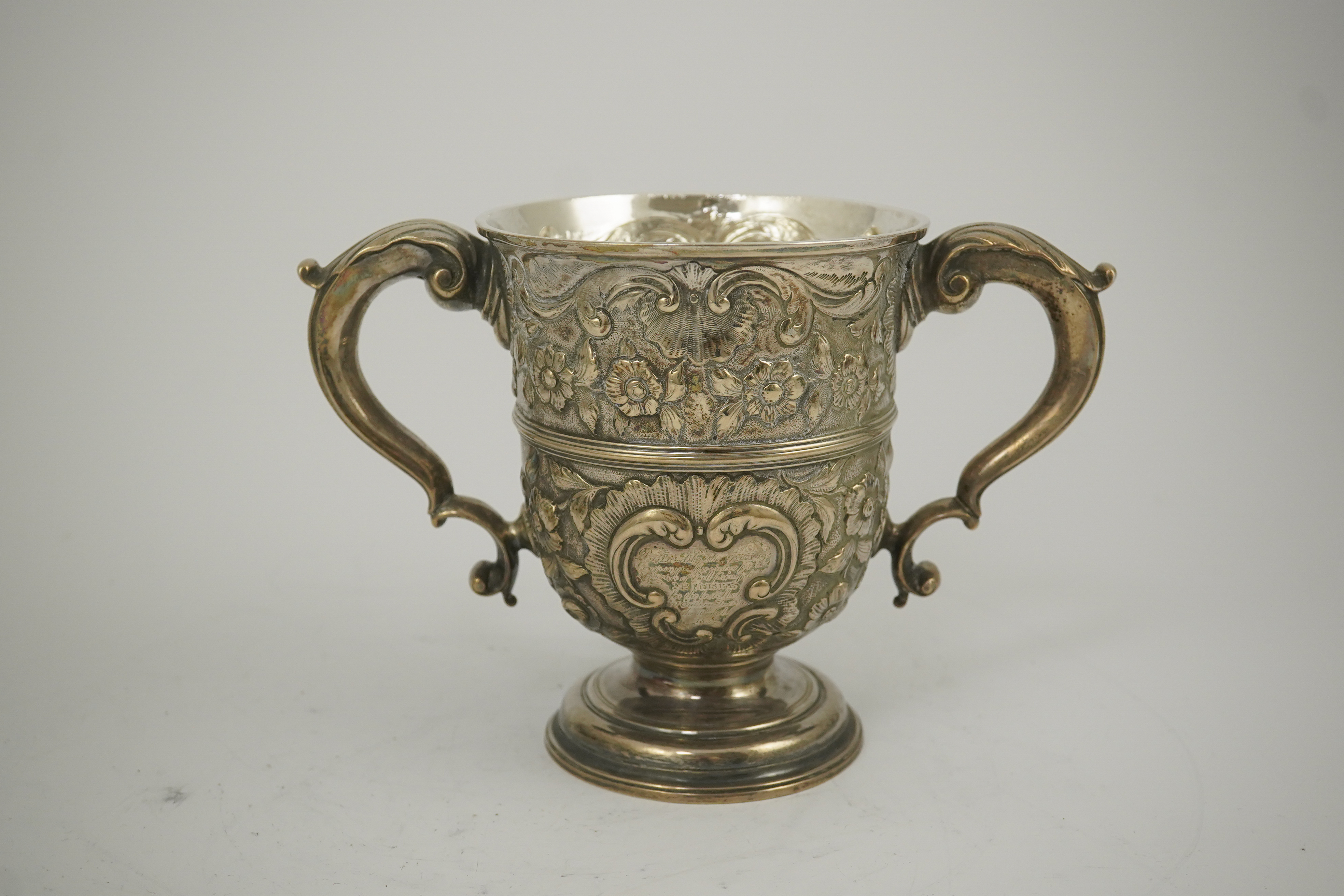 A George II silver loving cup with later floral embossed decoration, maker's initials RI, London, 1745